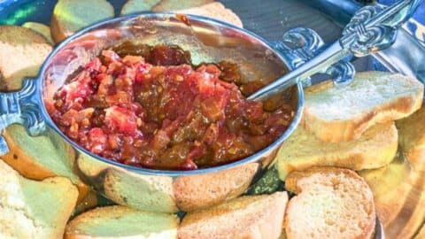 tomato bacon jam in a silver bowl with toast points