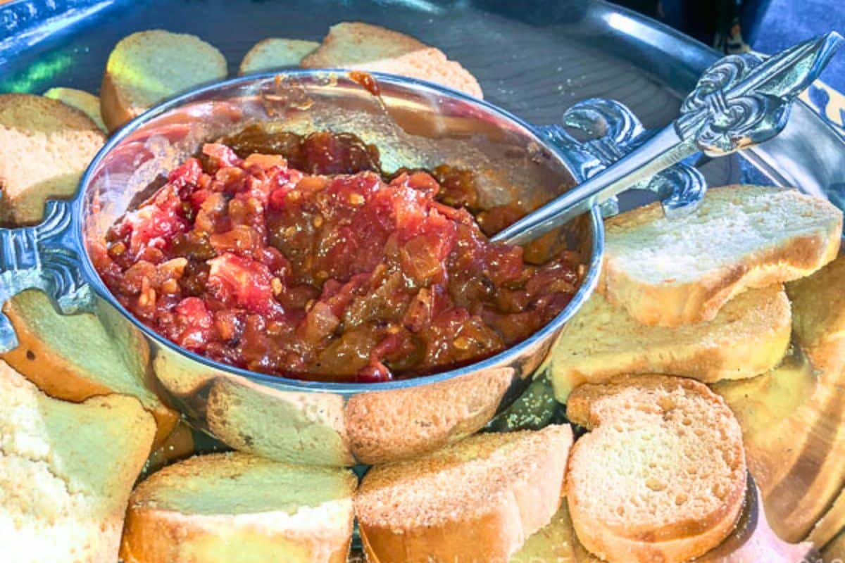 tomato bacon jam in a silver bowl with toast points