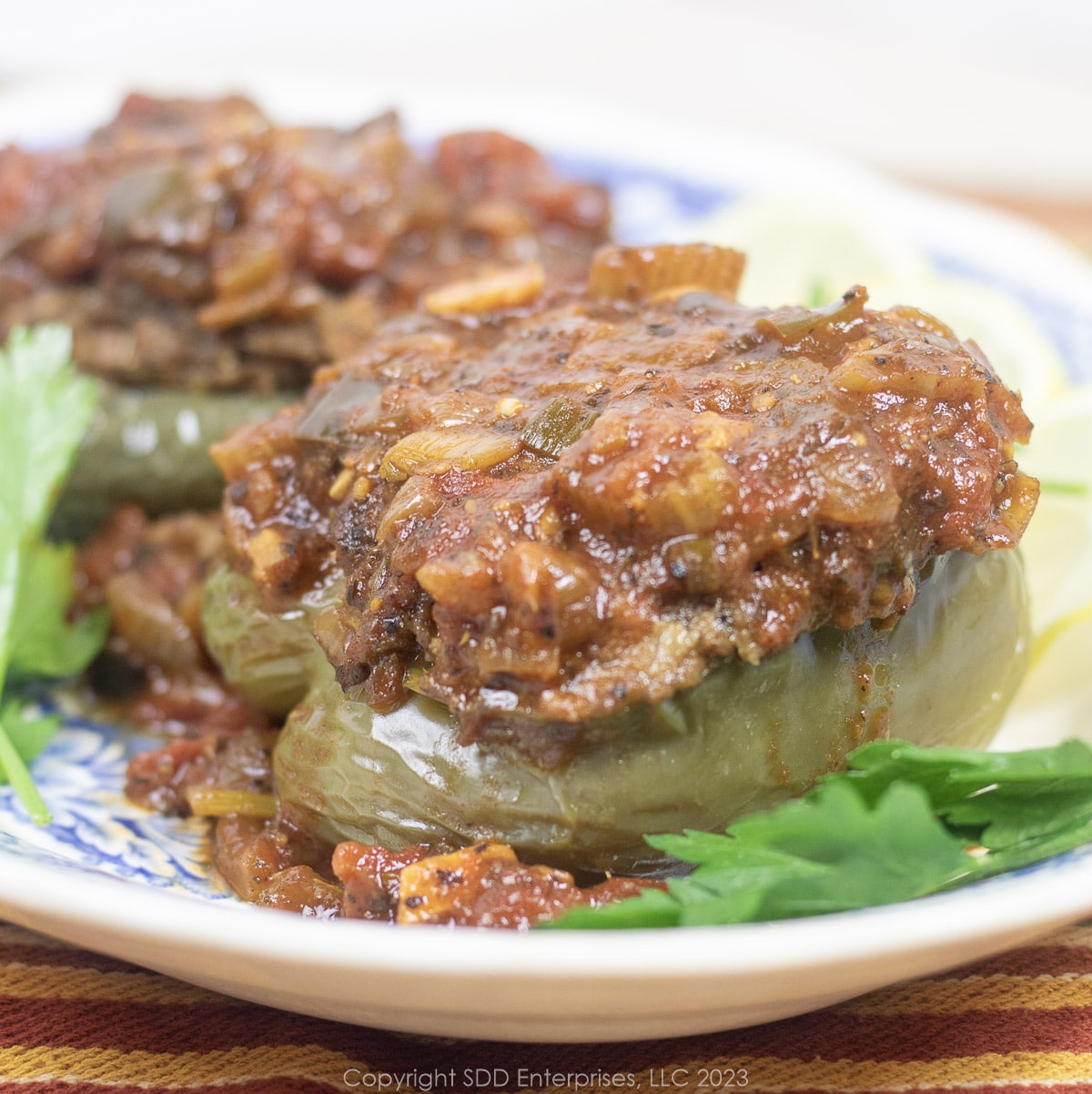 Creole Sauce served over Stiffed Bell Peppers on a platter with garnish.