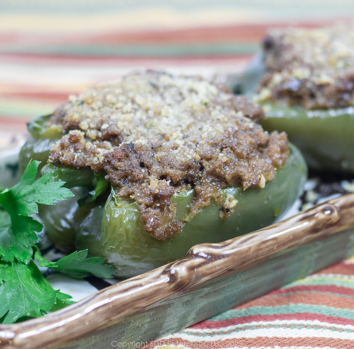 Stuffed Bell Peppers with garnish on a serving plate.