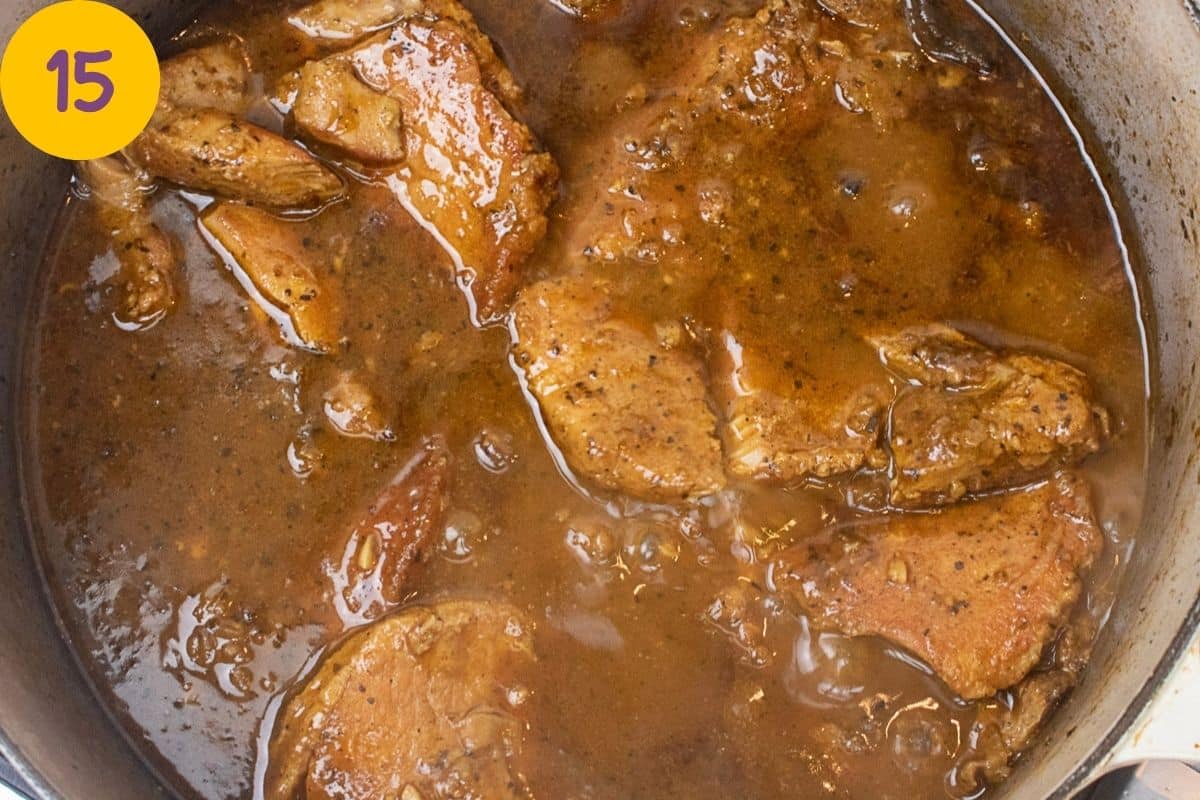 Smothered pork chops in a Dutch oven.