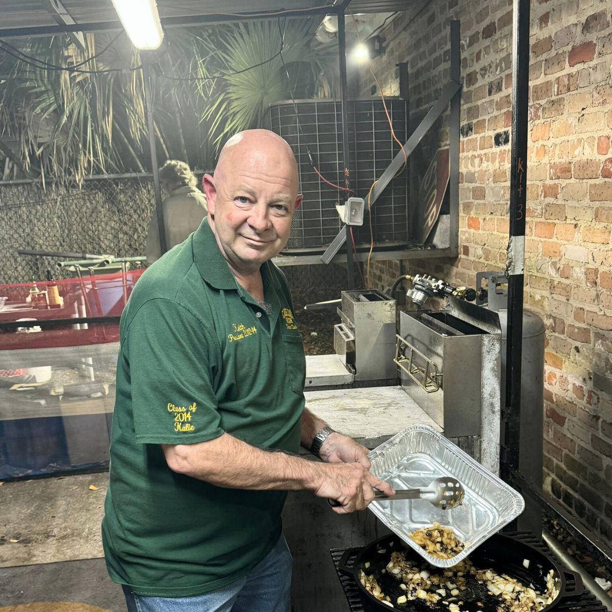 A Chef working at a grill.