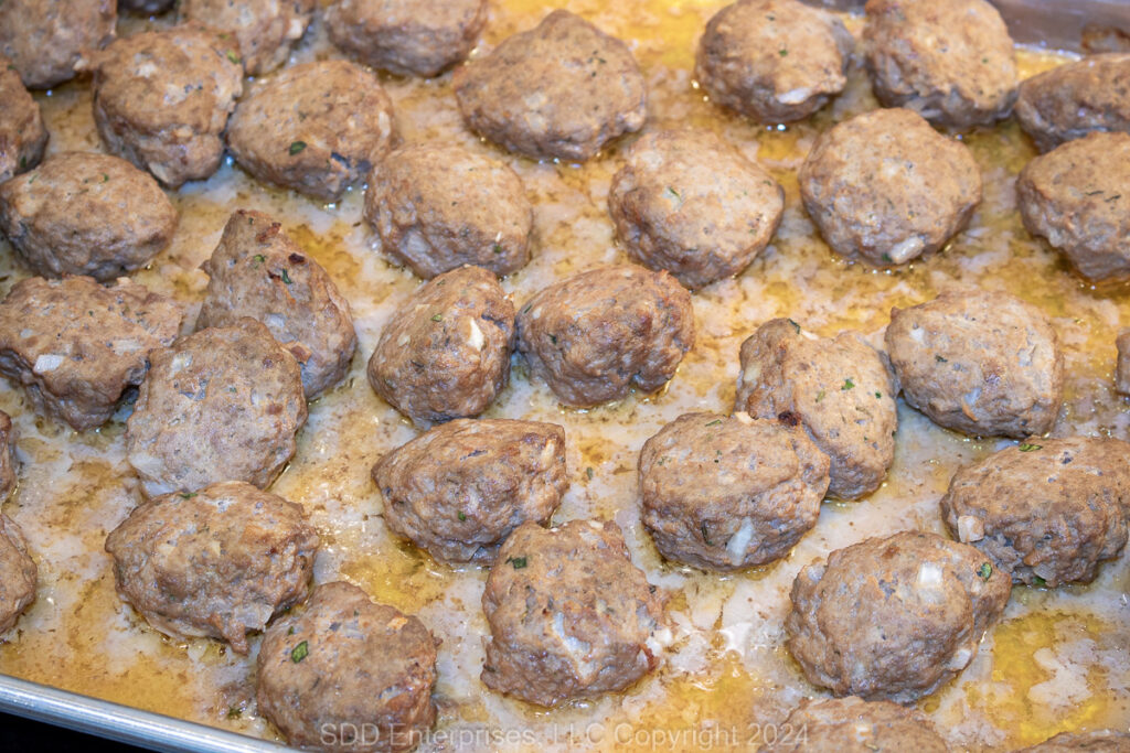 Cajun meatballs on a baking sheet right out of the oven.