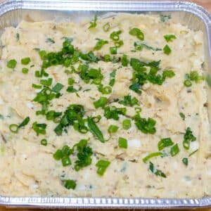 Creamy Cajun Potato Salad in a foil pan.
