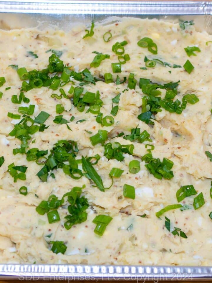 Creamy Cajun Potato Salad in a foil pan.