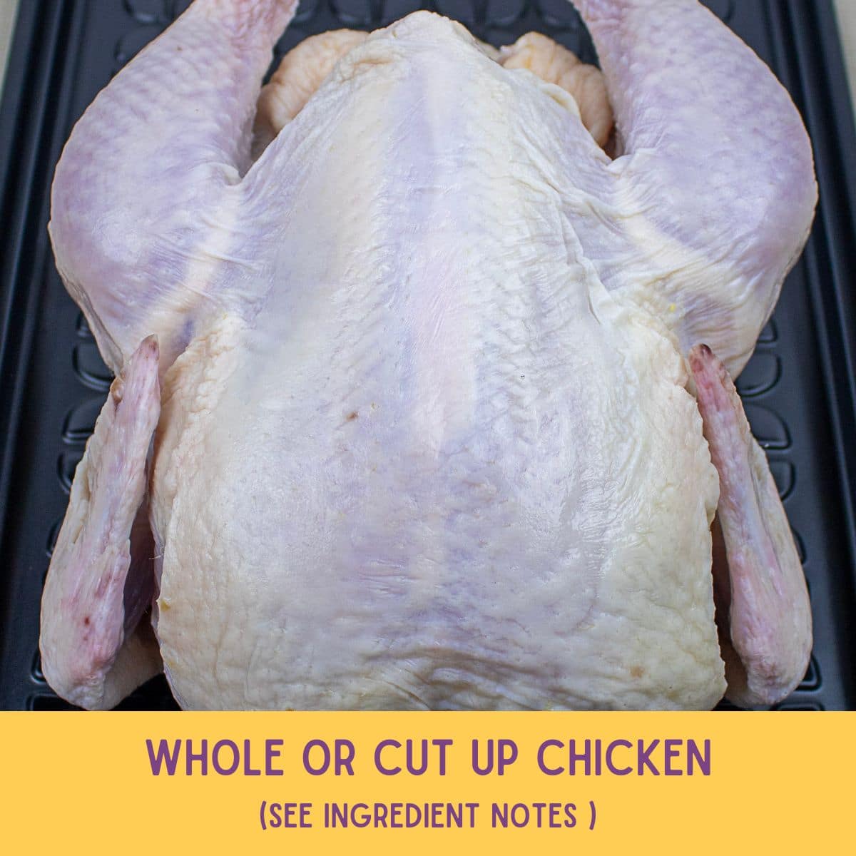 Whole raw chicken on a platter.