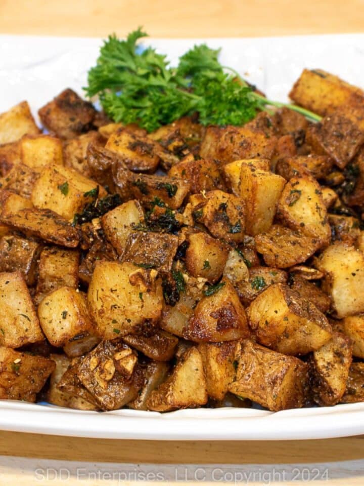 Brabant Potatoes with garnish on a white serving platter.