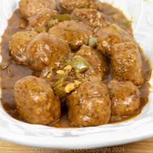 Cajun Meatballs in Brown Gravy on a white serving platter.