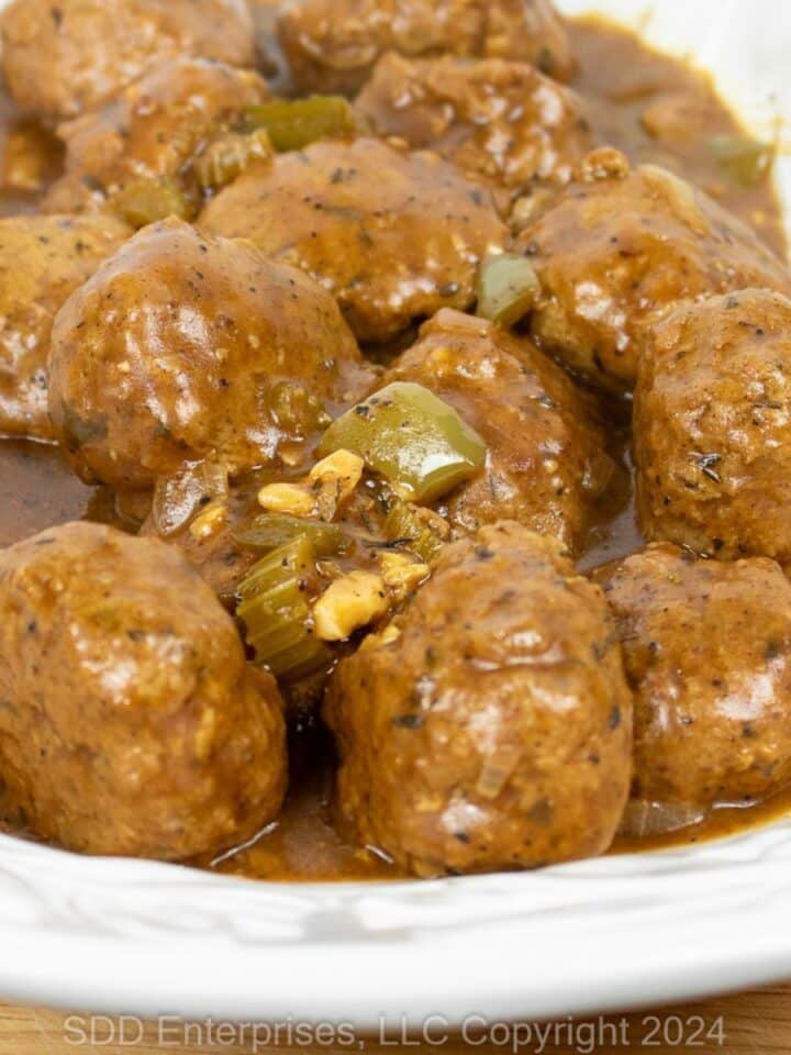 Cajun Meatballs in Brown Gravy on a white serving platter.
