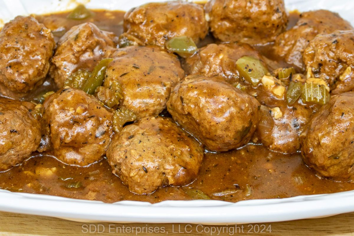 Meatballs in Gravy on a white serving platter.