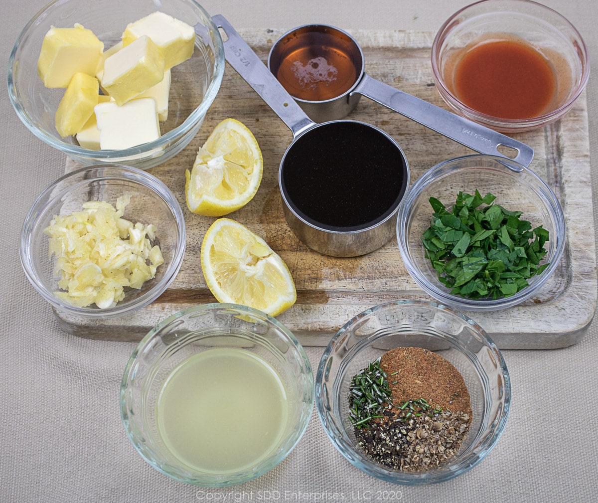 Prepared sauce ingredienst for BBQ Shrimp layed out on a cutting board.