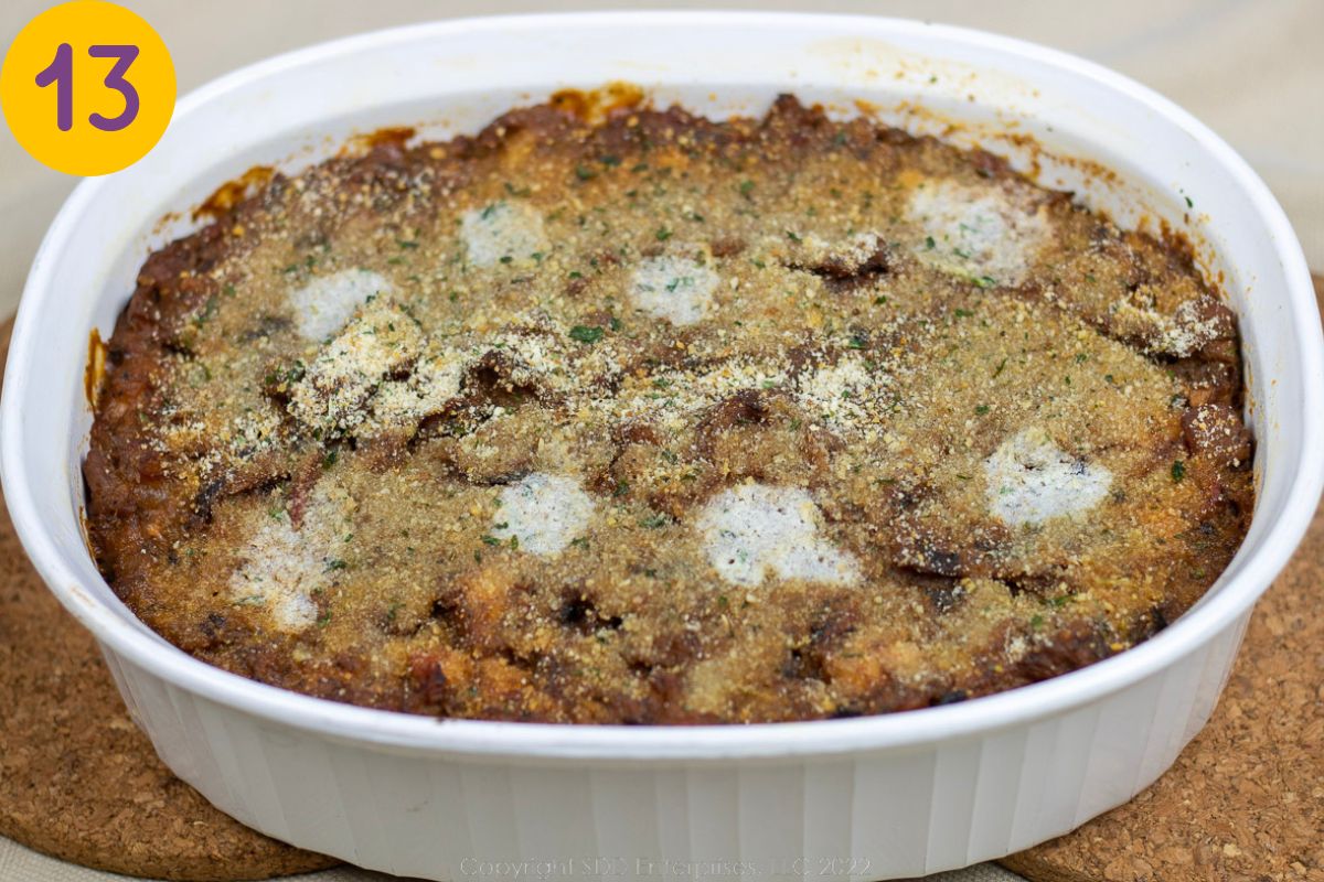 A baked Eggplant Casserole with Shrimp in a white baking dish.