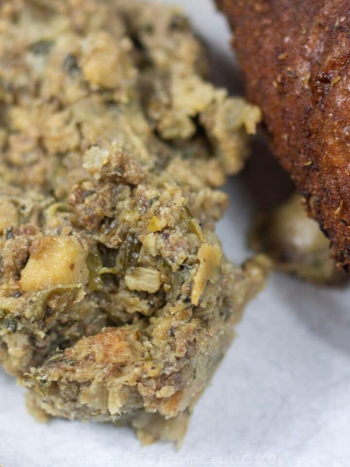 Oyster Dressing with roasted turkey on a plate.