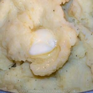 Garlic Mashed Potatoes with butter in a Dutch oven.
