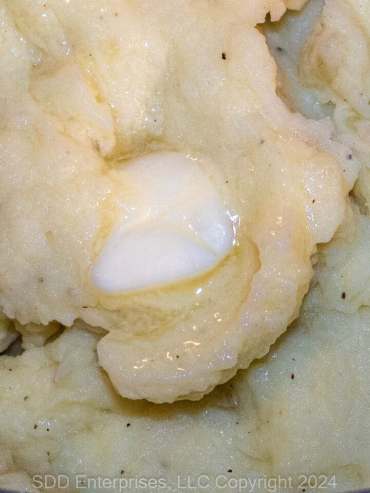 Garlic Mashed Potatoes with butter in a Dutch oven.