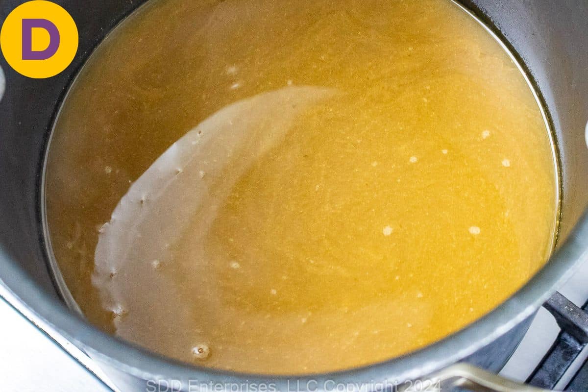 Seafood stock in a stockpot.