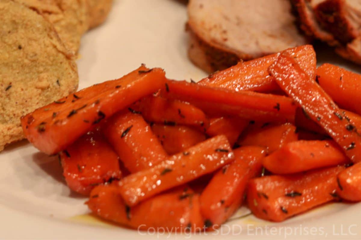 Roasted Carrots with Cane Syrup served  on a dinner plate.