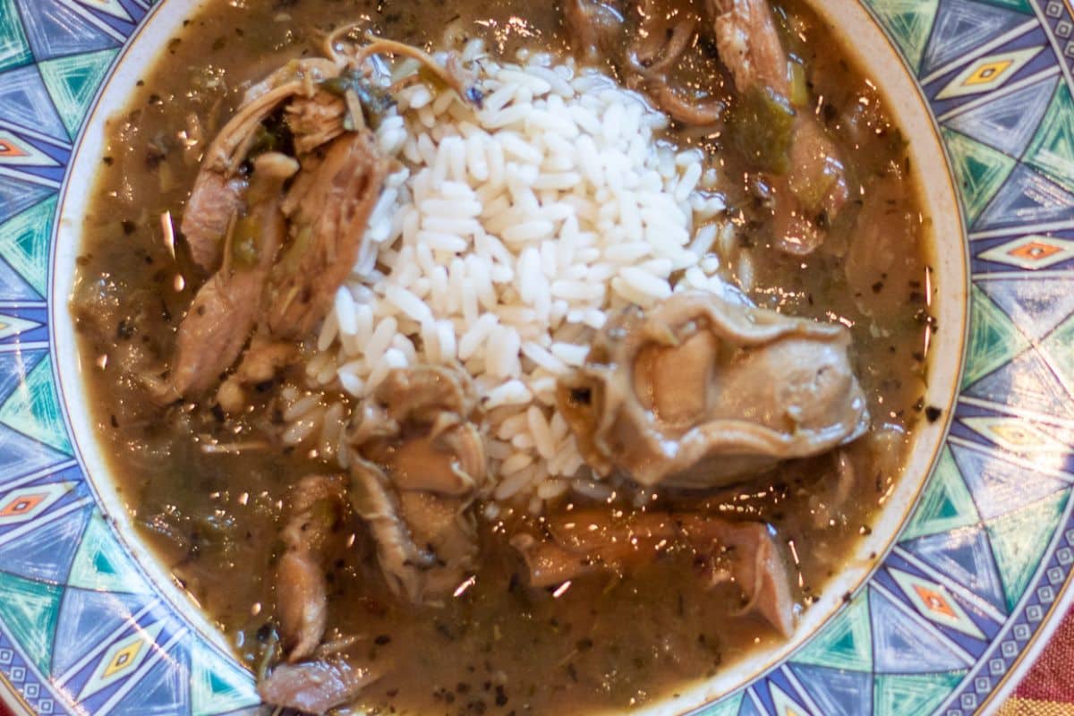 Tukey Oyster Gumbo with rice in a blue green bowl.