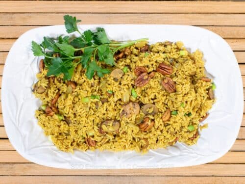 Pecan Rice on a white platter with parsley garnish.