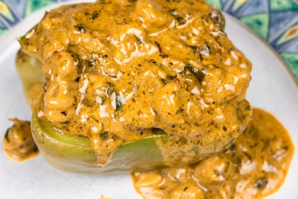 Cajun Stuffed Bell Peppers topped with Creamy Crawfish Sauce.