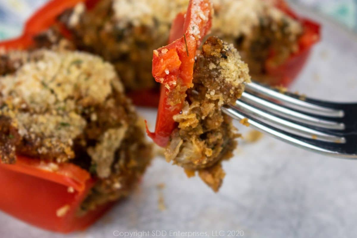 A bite of Bell Peppers with a crawfish filling on a fork.