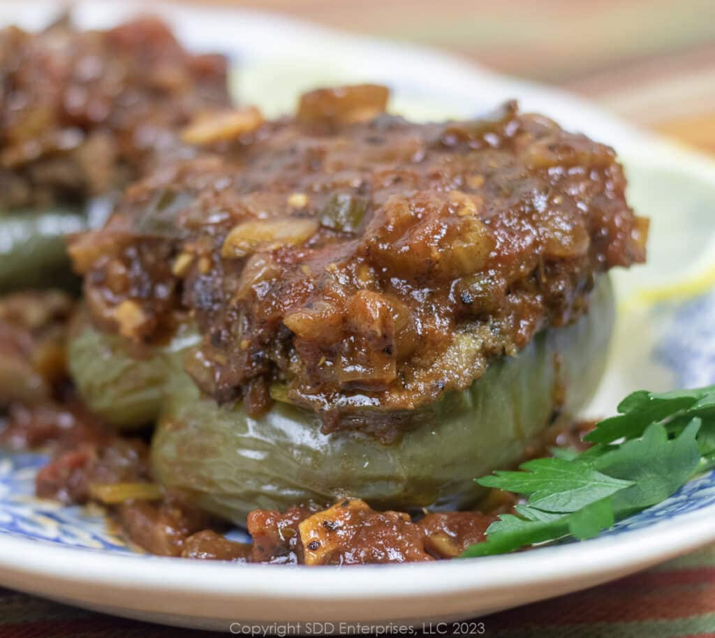 Cajun Stuffed Bell Peppers topped with Sauce Creole.