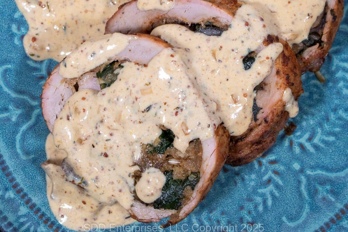 Sliced stuffed pork tenderloin with Sauce David.