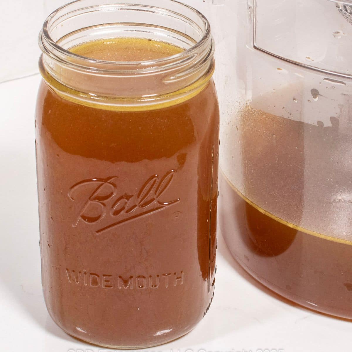 Homemade Chicken Stock in a glass jar.
