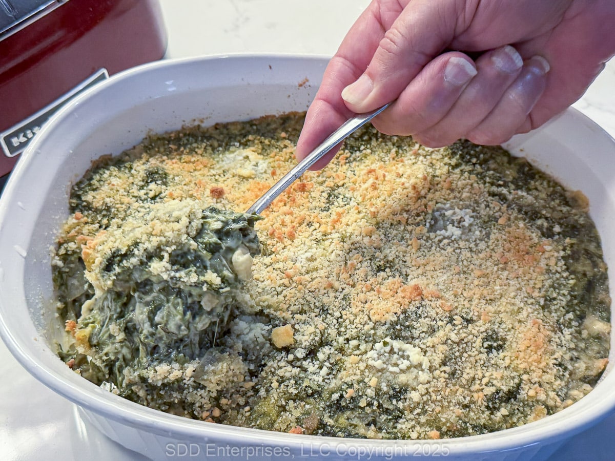 Creamed Spinach with Artichoke in a casserole baking dish.