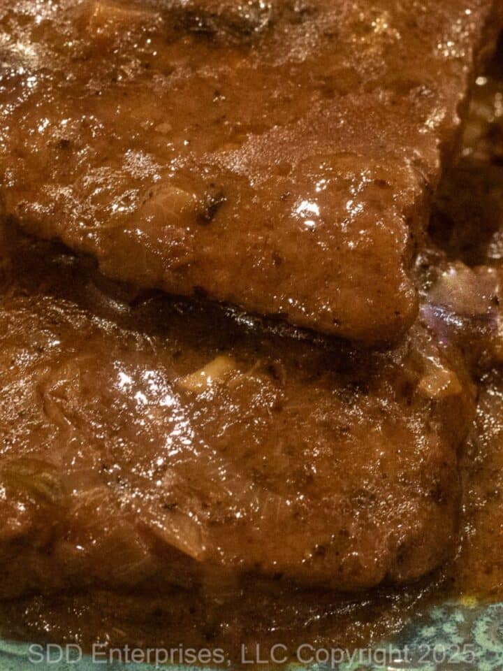 Smothered Round Steak on a serving plate.