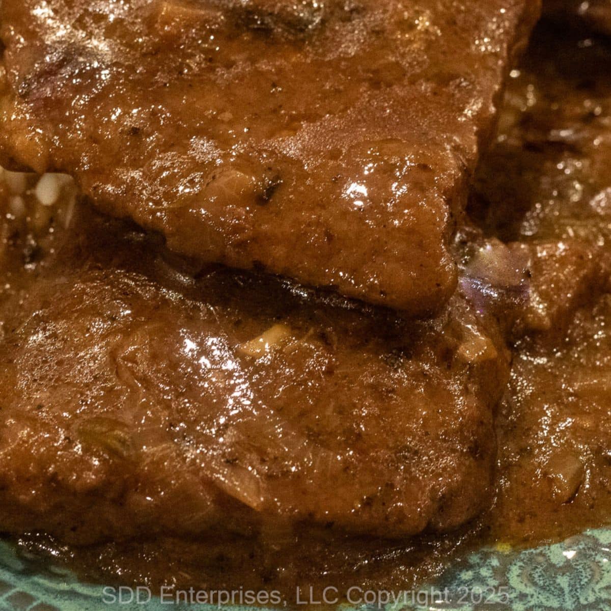 Smothered Round Steak on a serving plate.