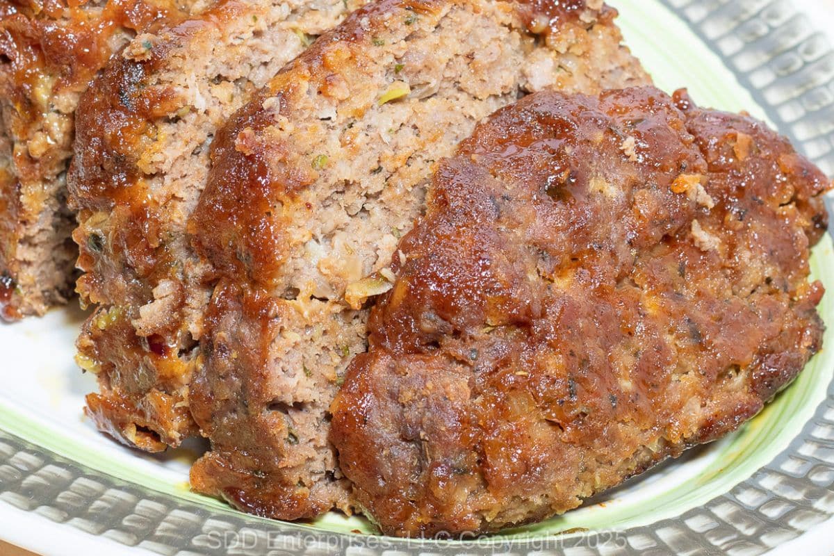 Sliced meatloaf on a serving platter.