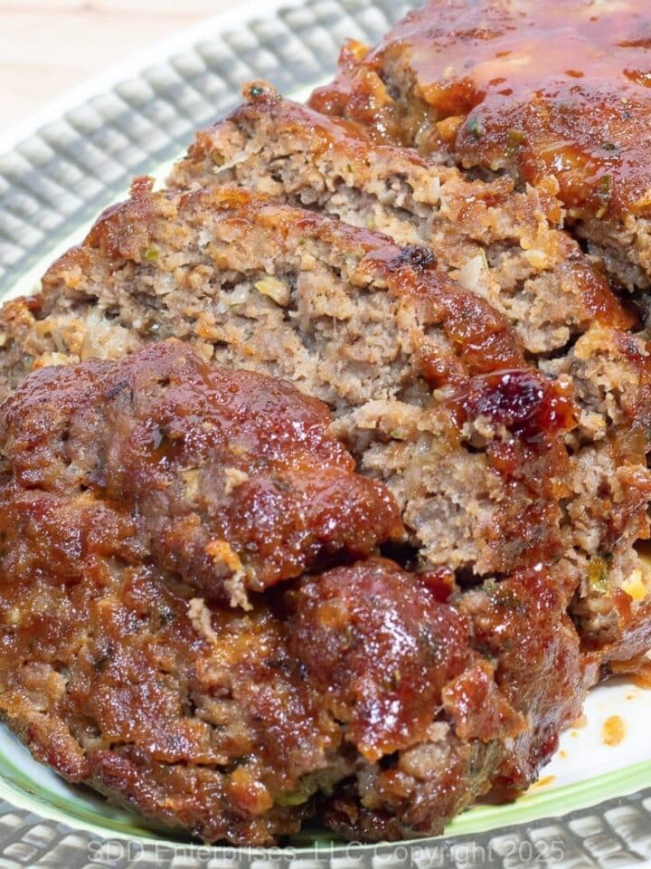 Sliced Meatloaf with Brown Glaze on a serving platter.