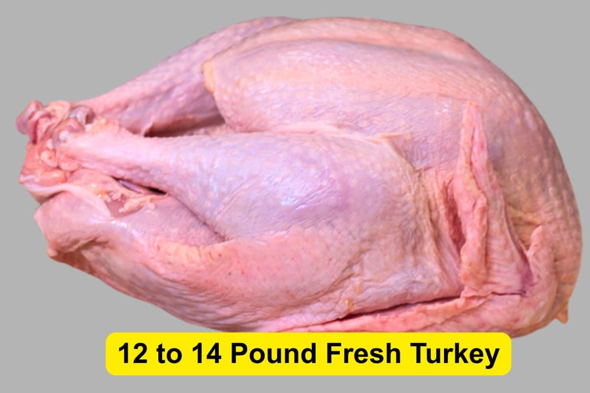 A whole uncooked 12–14 pound turkey on a neutral background.