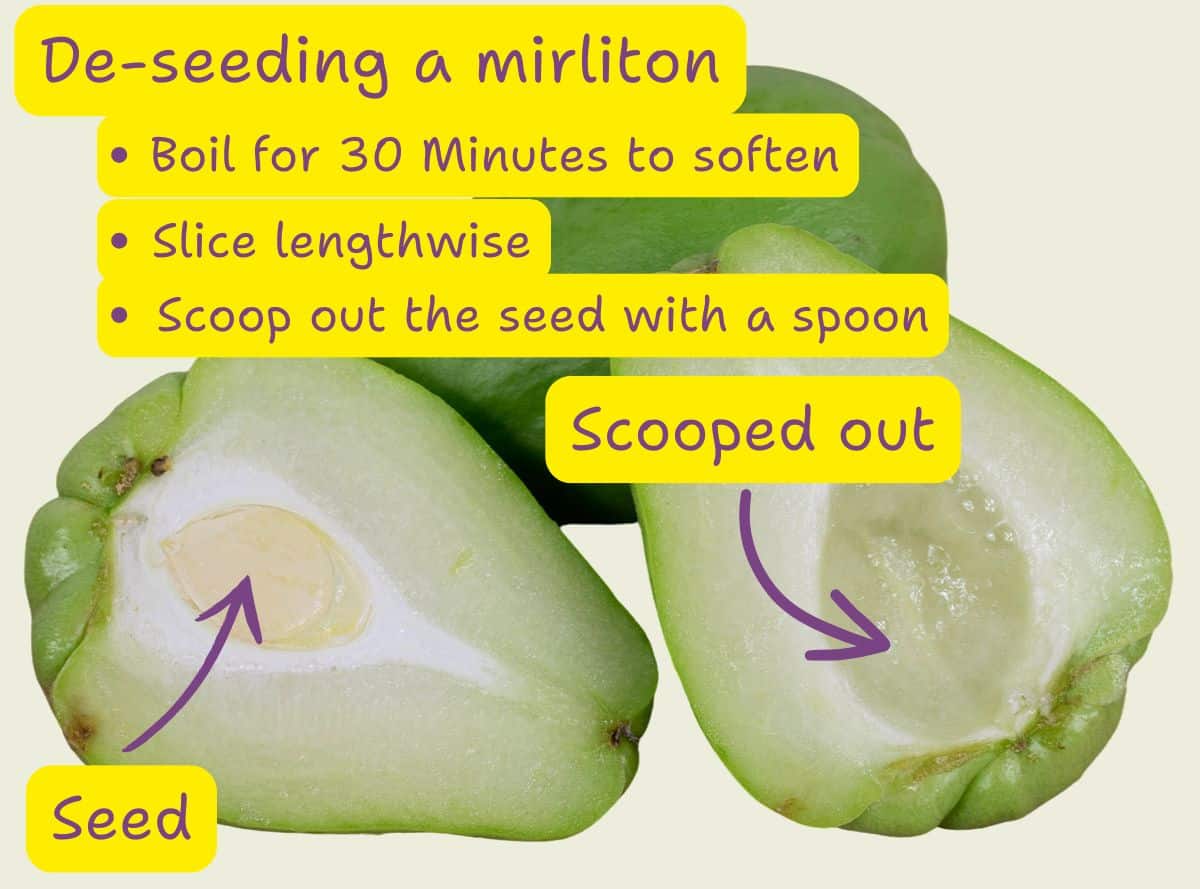 Cooked mirliton halves cooling on a rack, with flesh being scooped out for the stuffing mixture.