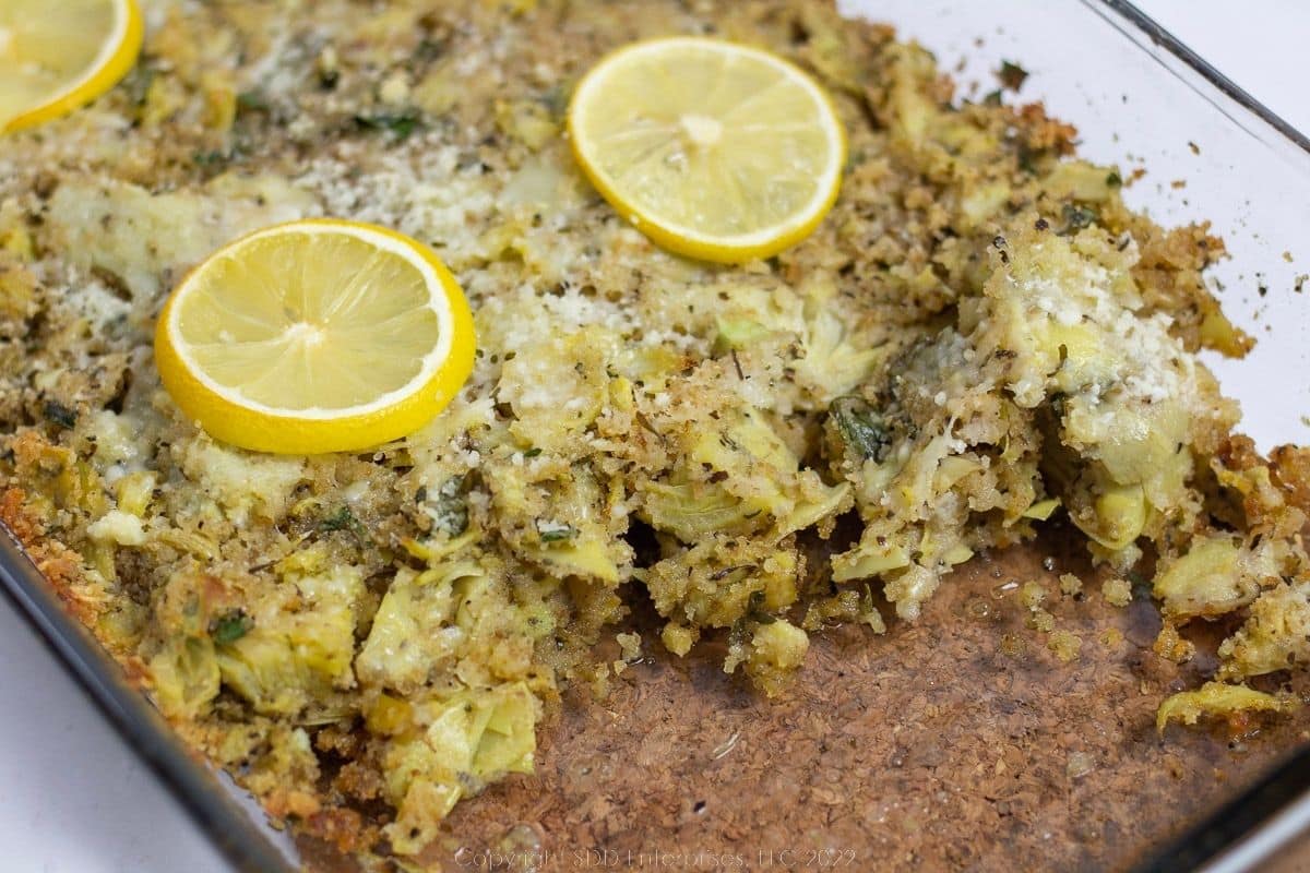Stuffed Artichoke Casserole in a glass baking dish.