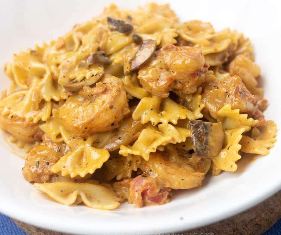 Creamy Shrimp Pasta with Mushrooms in a white serving bowl.
