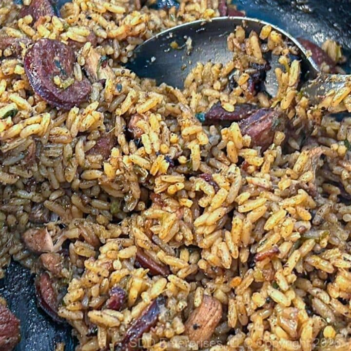 Cajun Jambalaya in a Dutch oven with a serving spoon.