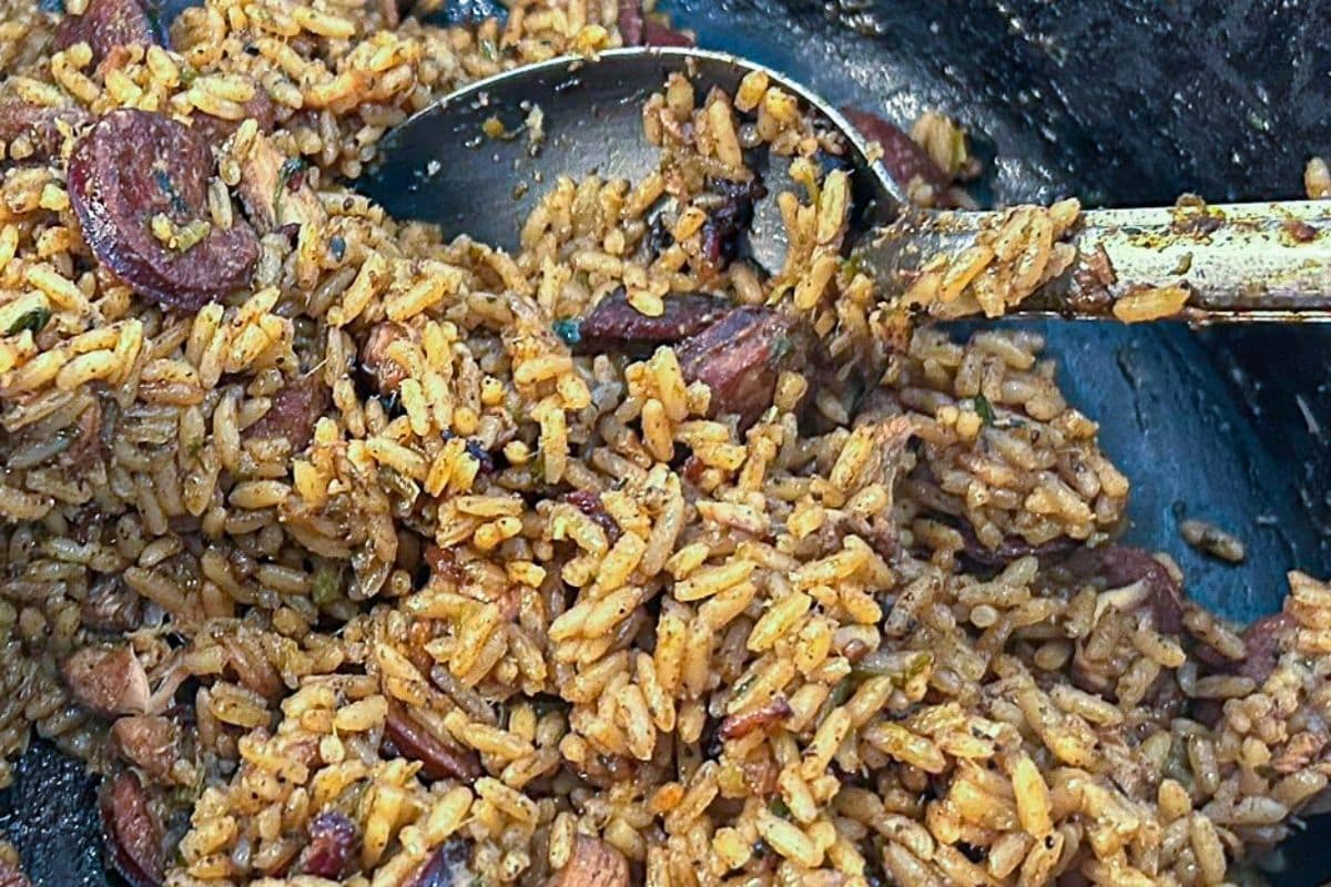 Cajun Jambalaya in a Dutch oven with a serving spoon.