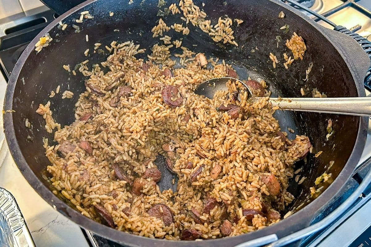 Cajun Jambalaya in a Dutch oven with a serving spoon.