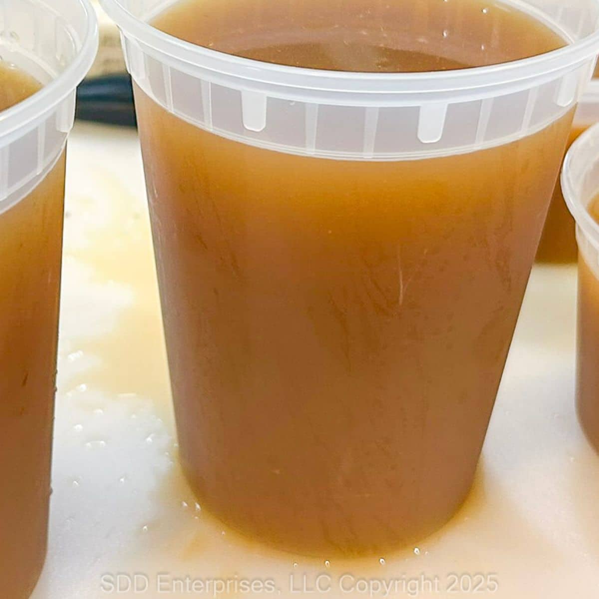 Homemade Shrimp Stock in freezer containers.