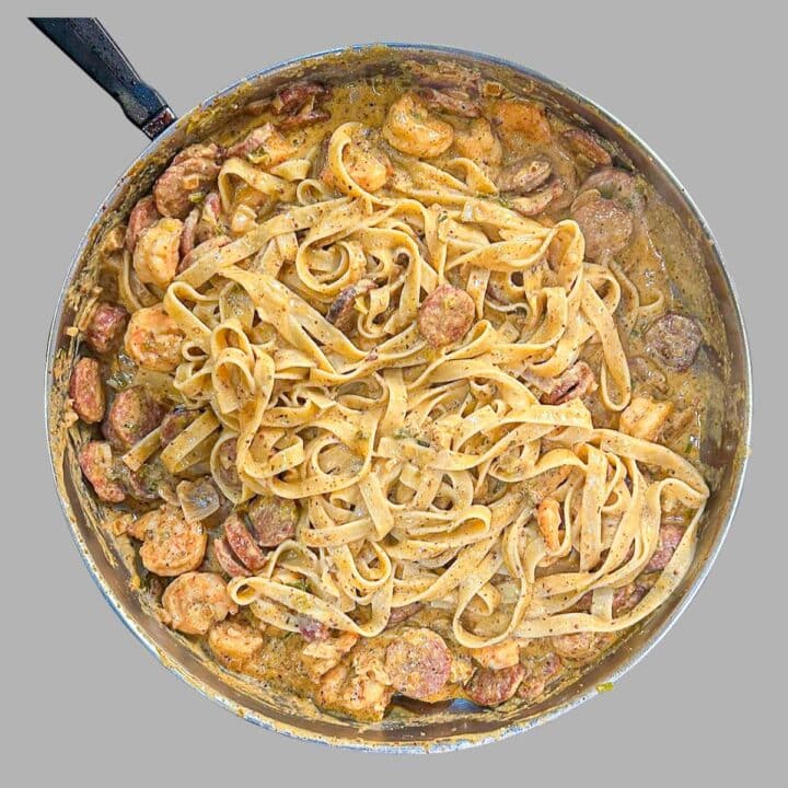 Shrimp and Andouille Pasta in Creole Mustard Sauce in a skillet.