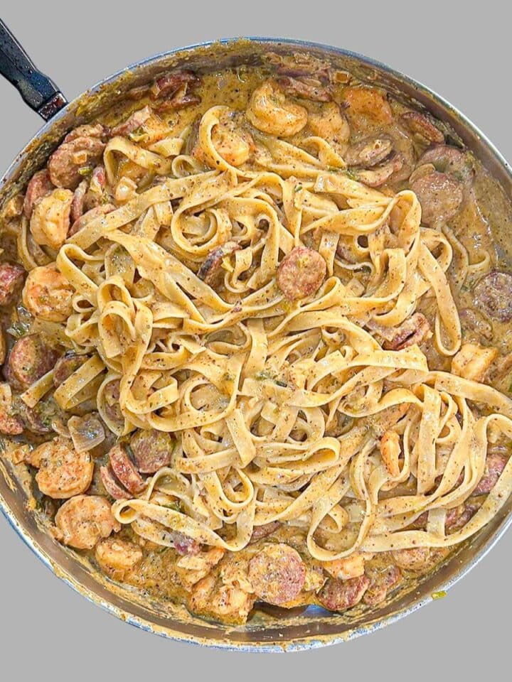 Shrimp and Andouille Pasta in Creole Mustard Sauce in a skillet.