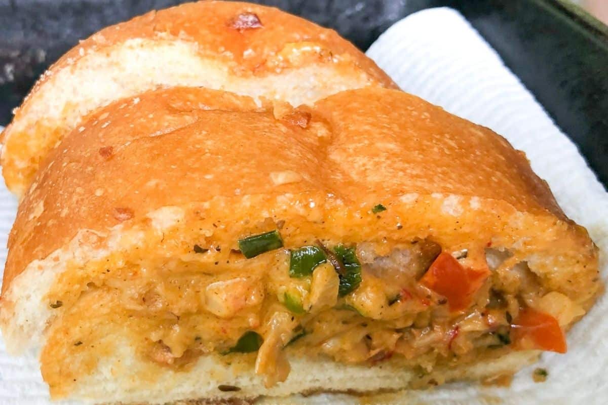Crawfish bread recipe baked and sliced on a serving board.