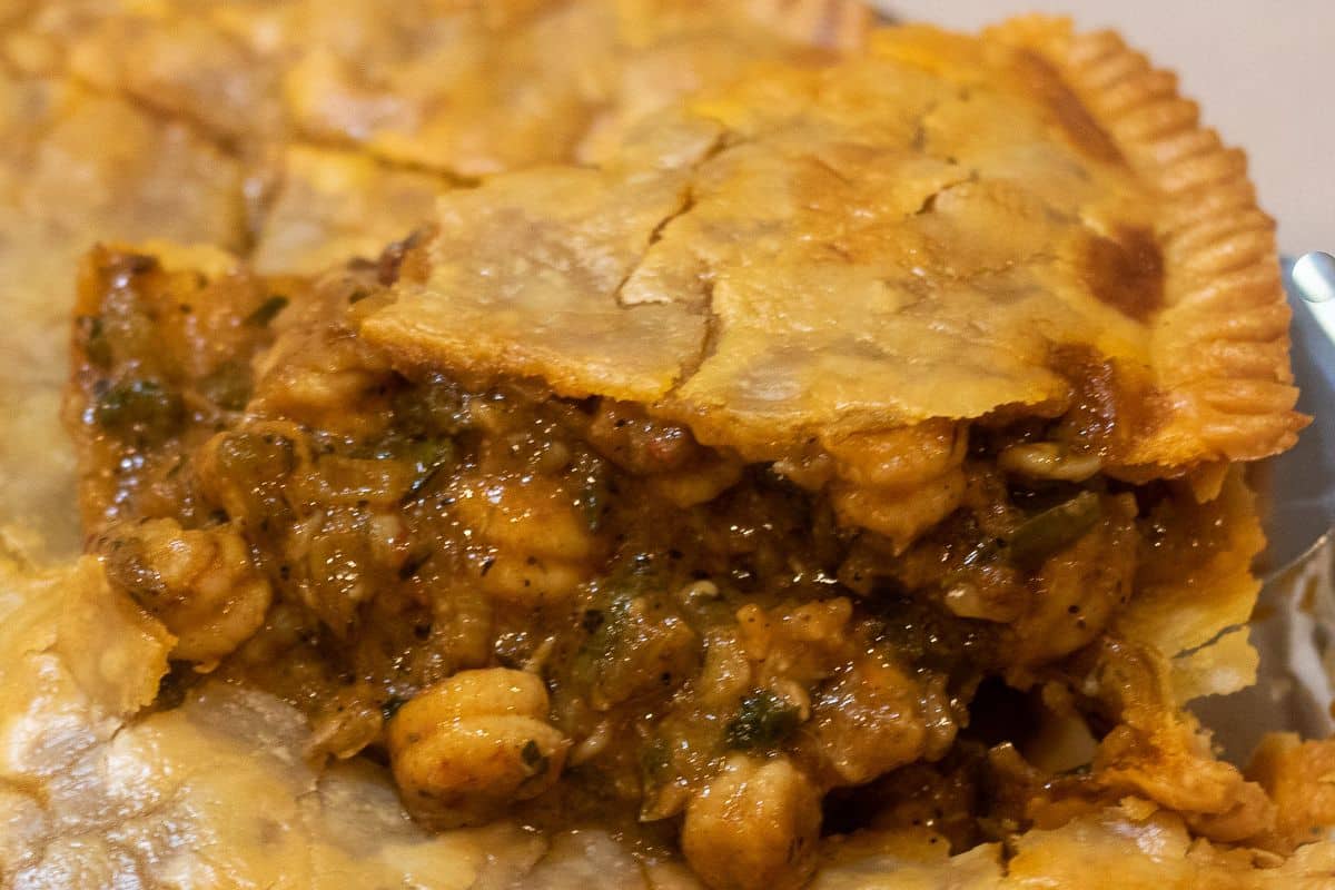 slice of crawfish pie showing rich filling and flaky crust on plate