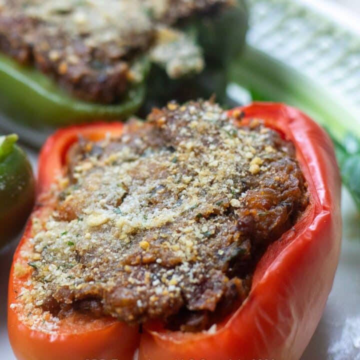 Red bell pepper stuffed with crawfish filling on a serving platter.