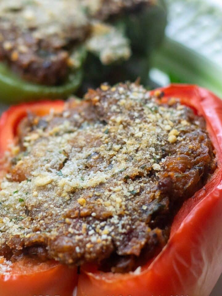 Red bell pepper stuffed with crawfish filling on a serving platter.