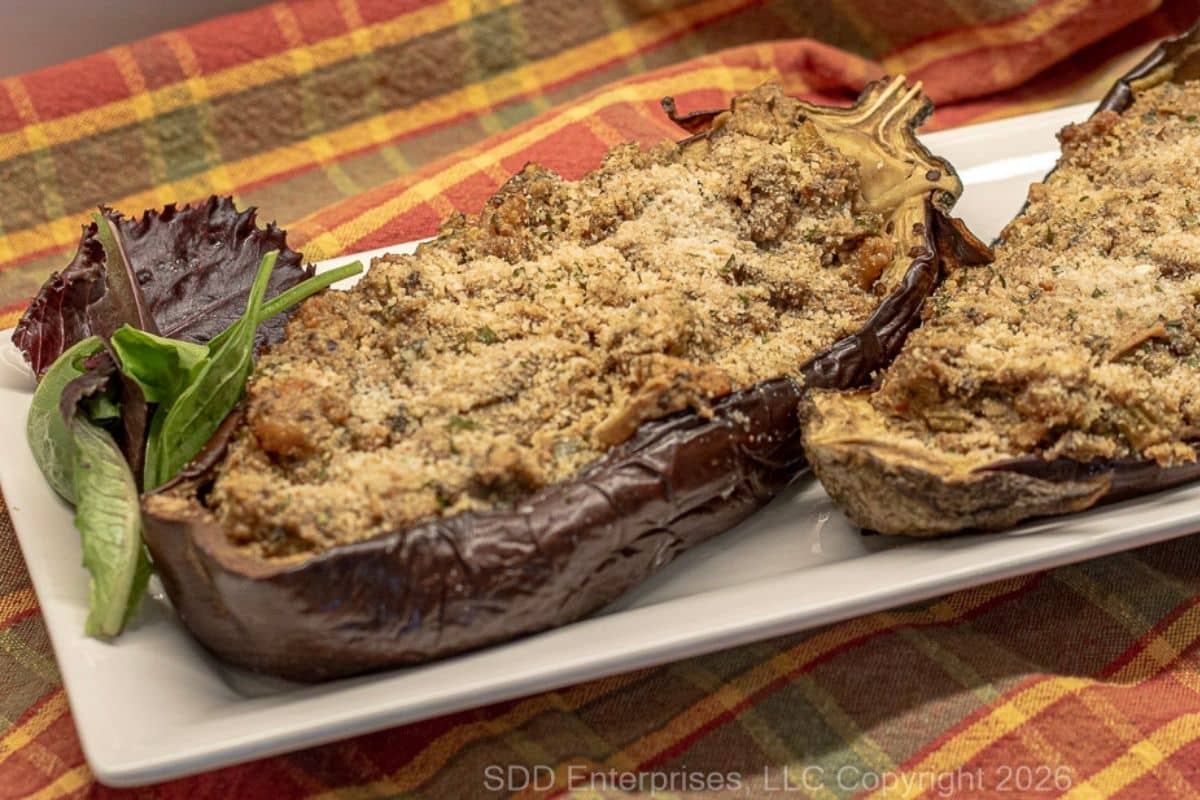 Shrimp stuffed eggplant plated and ready to serve with sides.