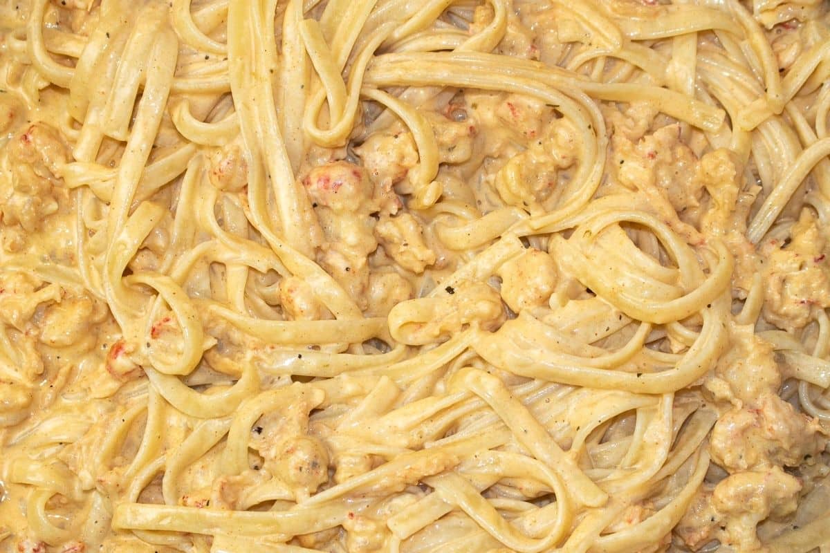 Bowl of creamy Crawfish Alfredo topped with parsley and Romano cheese.
