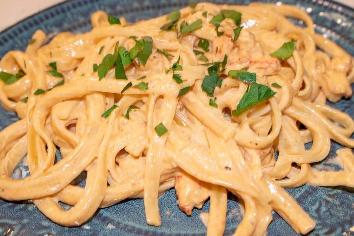 Creamy Crawfish Alfredo with Louisiana crawfish tails, fettuccine, Romano cheese, and parsley garnish.